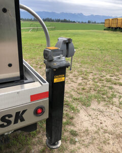 Image shows a vice mounted on the back of a Fisk propane truck with mountains in the background